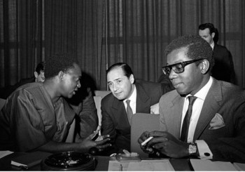 Special Committee of 24 on the ending of colonialism, United Nations Headquarters, New York: Mr. John S. Malecela (Republic of Tanzania), Chairman of the Committee (left), conversing with Mr. Mateo Marques-Sere (Uruguay), during the Committee’s consideration of the situation of six Caribbean territories (Antigua, Dominica, Grenada, St. Kitts-Nevis-Anguilla, St. Lucia and St. Vincent), 21 February 1967. Image via United Nations Audiovisual Library of International Law.